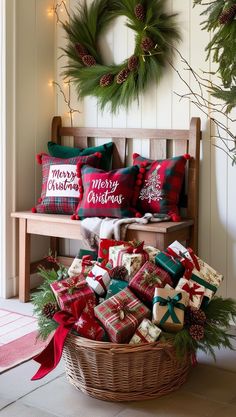 a basket filled with presents sitting on top of a wooden bench next to a wreath