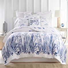 a bed with blue and white comforters in a bedroom