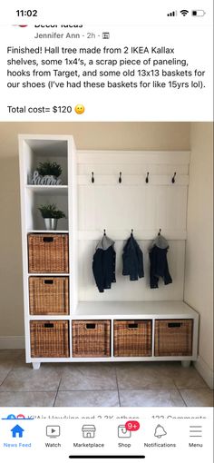 a white shelf with baskets and clothes hanging on it