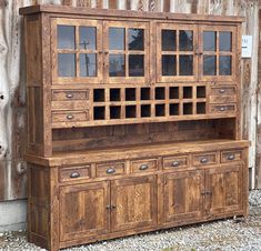 an old wooden hutch with glass doors and drawers