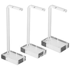 three clear acrylic display stands on white background