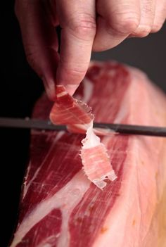 a person cutting up meat with a knife