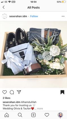 an open box with shoes and flowers on it