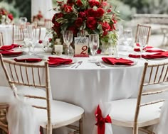 the table is set with white linens and red napkins