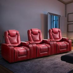 three red reclining chairs in a living room