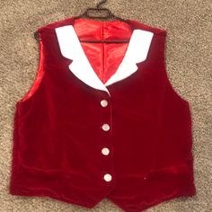 a red velvet vest with white collar and buttons