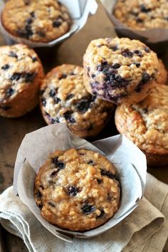 blueberry muffins in paper cups on a table