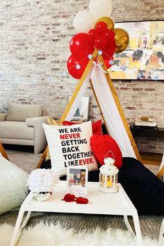 a living room filled with furniture and balloons in the shape of a teepee tent