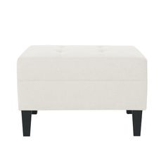 a white ottoman with black legs and an upholstered foot rest on the bottom