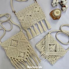 three white purses, one with tasseled handles and the other with crochet