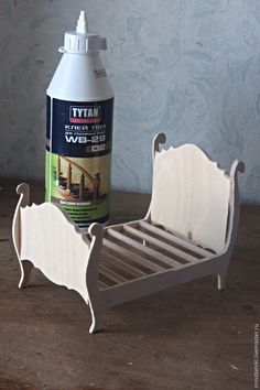 a wooden bed frame next to a bottle of cleaner