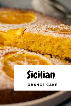 an orange cake with powdered sugar on top and the words sicilian written in black