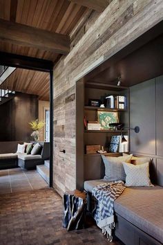 a living room filled with furniture and bookshelves next to a wooden flooring wall