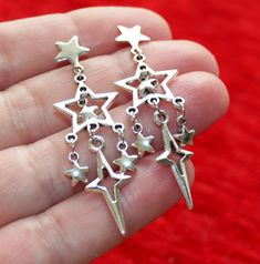 Dull silver tone star charm earrings. Earring length: 52mm; 2" (from the top to end) Earring stud material: 316L stainless steel Charm material: Zinc alloy, Nickel safe, Lead free This listing is for one pair of star earrings with rubber backs. These earrings will come in a gift bag. I offer combined shipping costs which give you a shipping discount for ordering multiple items from my shop. Earrings care: Take them off while you sleep, do sports activities, bathe, having a shower. Avoid contact Jewelry Accessories Ideas, Earring Stud, Funky Jewelry, Jewelry Inspo, Dream Jewelry, Star Charms, Pretty Jewellery, Ear Jewelry, Star Earrings