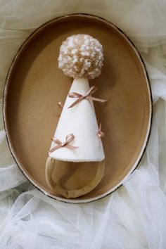 a plate with a small cone shaped object on it's side and ribbon tied around the top