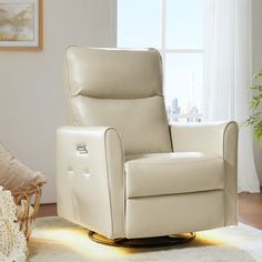 a white recliner chair sitting in front of a window next to a rug and potted plant