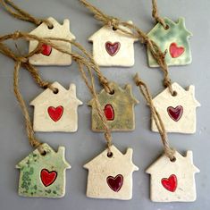 small ceramic houses with hearts hanging from twine