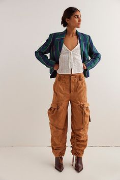 So slouchy and forever cool, this new take on the classic cargo silhouette from our We The Free collection will be a staple for seasons to come. **Fit:** Low-slung, wide cargo silhouette **Features:** Zip fly and hidden closure, oversized workwear pockets, tassel tie detailing, smocked waistband for ease **Why We ❤ It:** Sporty with classic sneakers or toughened-up with moto boots, this pair has endless ways to wear. | We The Free Everglades Utility Pants at Free People in Brown, Size: L Fall Utility High-waisted Cargo Pants, Trendy Cargo Pants With Patch Pockets For Fall, High-waisted Cargo Pants With Patch Pockets For Fall, Trendy Fall Parachute Pants With Cargo Pockets, Trendy Fall Cargo Pants With Flap Pockets, Trendy Parachute Pants With Cargo Pockets For Fall, Fall Utility Parachute Pants With Tapered Leg, Fall High-waisted Cargo Pants With Flap Pockets, Fall Fitted Utility Cargo Pants