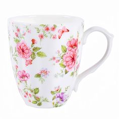 a white coffee cup with pink and purple flowers painted on the outside, sitting in front of a white background