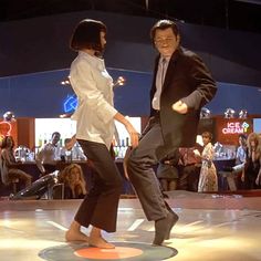 two people are dancing on the dance floor