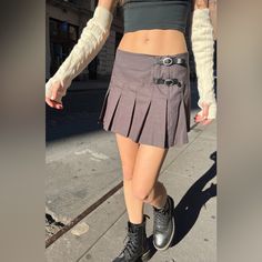 Low Waisted, Pleated Skirt With Leather Buckles And Zip Closure. Fabrics: 100% Cotton Measurements: 12.5" (32 Cm) Length, 29" (74 Cm) Waist Made In: China Y2k Fitted Pleated Skirt, Y2k Style Mini Skirt For Fall, Y2k Mini Skirt For Fall, Y2k Fall Mini Skirt, Y2k Mini Skirt With Belt Loops, Y2k Style Short Pleated Skirt, Y2k Mini Skirt With Lining, Y2k Mini Skirt Lined, Y2k Mini Lined Skirt