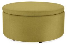 a large round ottoman with wheels on the bottom and an upholstered seat cushion