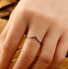 a woman's hand with a diamond ring on it