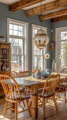 a dining room with blue walls and wooden furniture