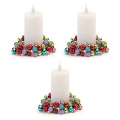 three white candles with christmas decorations around them on a white background, set of 3