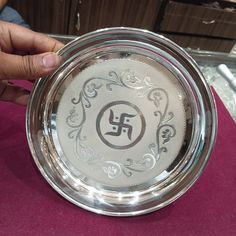 a person holding a glass bowl with the letter f on it