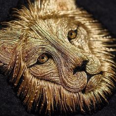 a close up of an animal made out of gold thread