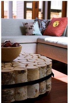 a table made out of wine corks in front of a couch with pillows on it