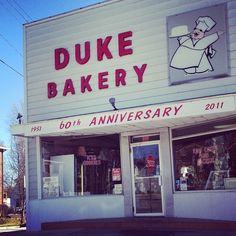 the front of a bakery with signs on it