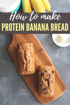 two banana breads sitting on top of a wooden cutting board next to some bananas