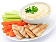 hummus, carrots and celery sticks on a plate