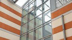 an orange and white building with a clock on it's side