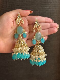 These light weight long blue kundan statement earrings are the perfect addition to any traditional outfit. featuring a big central stone and a Jhumka, these earrings are unique and sure to make a statement. they are high quality but still easy on your ears to wear as they feel very light weight.  also available in a beautiful yellow colour!  shop now! for any queries, please feel free to reach out to us. Luxury Blue Bollywood Earrings, Luxury Bollywood Blue Earrings, Luxury Kundan Jhumkas With Latkans, Luxury Formal Jhumkas With Latkans, Luxury Blue Chandbali Danglers, Cheap Party Earrings For Diwali, Luxury Kundan Jhumkas For Eid, Luxury Kundan Jhumkas With Gota Work, Luxury Fusion Style Jhumkas With Latkans