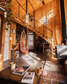 the inside of a house with wood paneling and exposed ceilings, windows, and an open floor plan