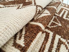 a brown and white blanket on top of a bed