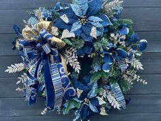 a christmas wreath with blue and gold decorations