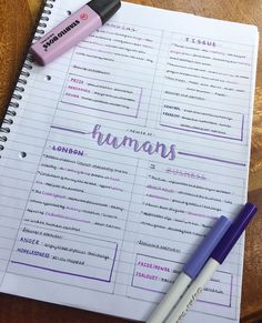 a notebook with the word humans written on it next to a pen and eraser