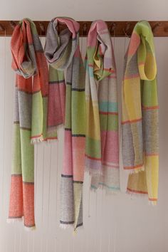 multicolored striped scarfs hanging from hooks