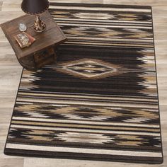 an area rug with a table and lamp on it