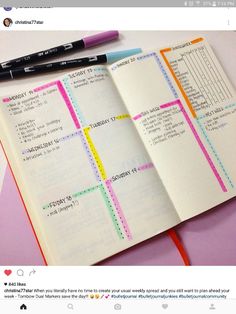 an open notebook with colorful lines on it and a pen resting on top of the page