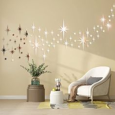 a living room filled with furniture and star wall decals on the side of the wall