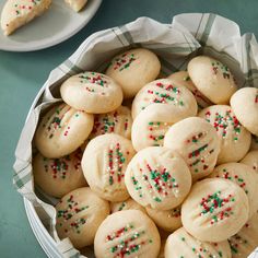 cookies with sprinkles in a bowl on a table