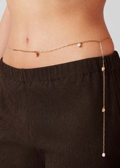 The lightweight summer body chain you'll love to live in.  a box chain is peppered with freshwater pearls teeny nautilus shells and a conch charm. drape it around your waist or hips. wear at your preferred length using the paperclip chain extender and removable extender (which adds an extra 5"). finished in high-polish gold.    note: as a result of the natural quality of pearls you may notice variations in color and shape which is entirely normal and reflects the unique characteristics of each element.    gold ion plated steel  freshwater pearl  finish: high polish  lobster clasp    product measurements:  chain width: 1.85mm / 0.07"  extender chain length: 12.7cm / 5"  approx. freshwater pearl length: 9mm / 0.35"  approx. freshwater pearl width: 6.8mm / 0.27"  shell length: 12mm / 0.47"  s Nautilus Shell, Jenny Bird, Swimming Bag, Sweater Jumpsuit, Four Horsemen, Unique Characteristics, Chain Extenders, Summer Body, Chain Belt