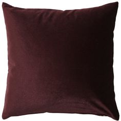 a dark purple velvet pillow on a white background