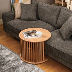 a living room with a couch, coffee table and rug