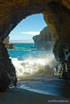 an ocean cave with waves crashing into the rocks